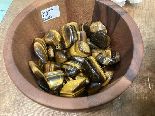 Assorted loose gold tiger's eye stones.