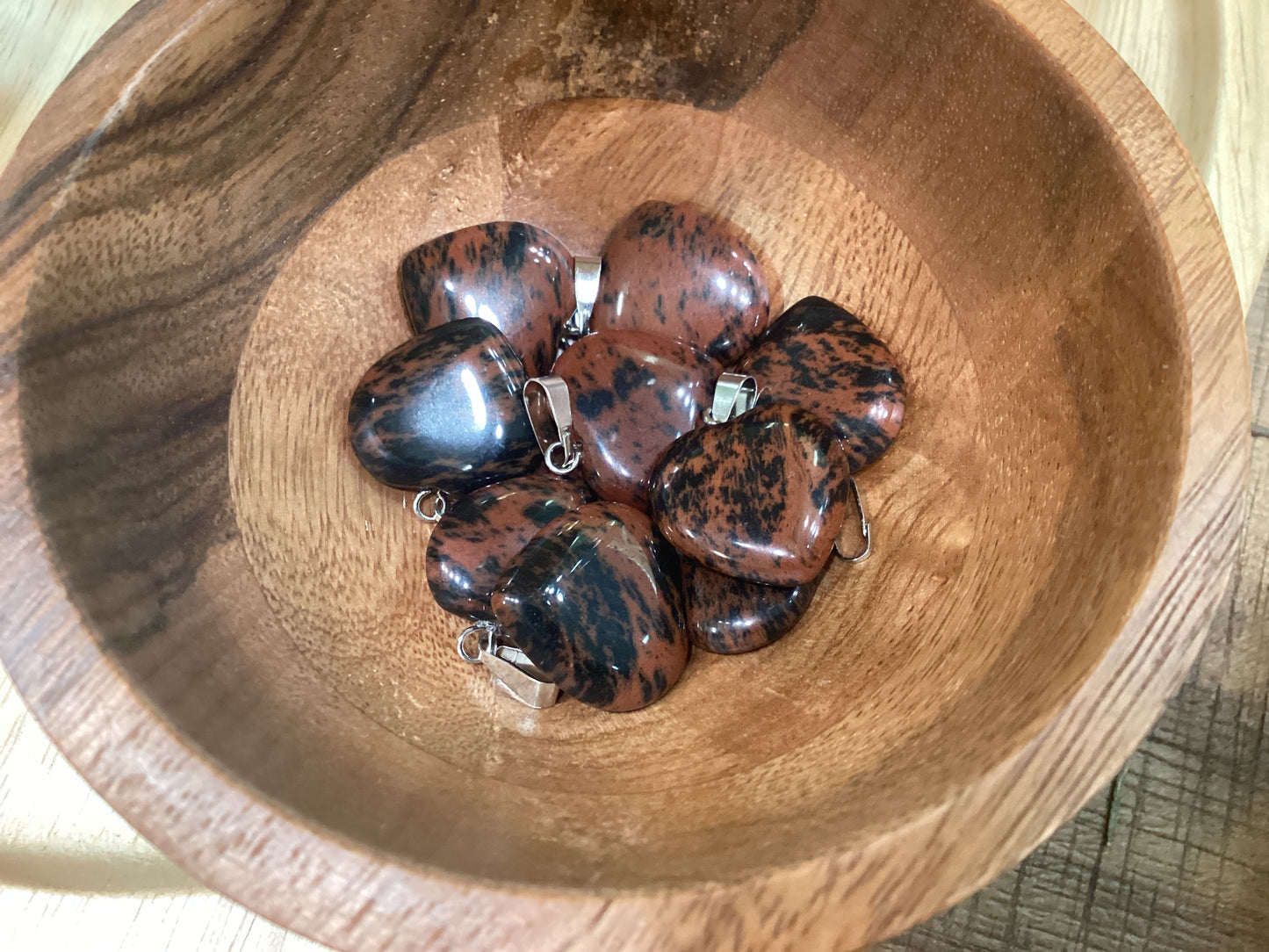 Heart-shaped mahogany obsidian necklace charms with silver clasps.