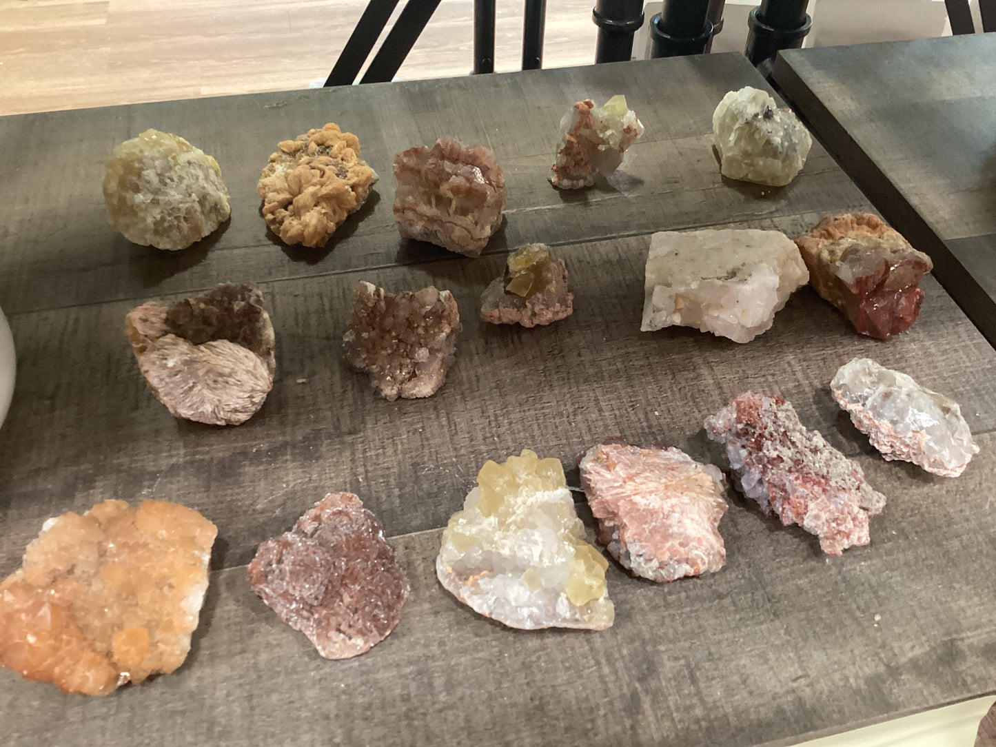 Assorted loose epidote crystals on stones.