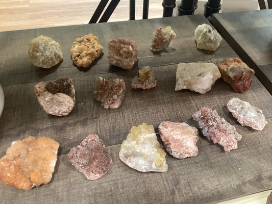 Assorted loose epidote crystals on stones.