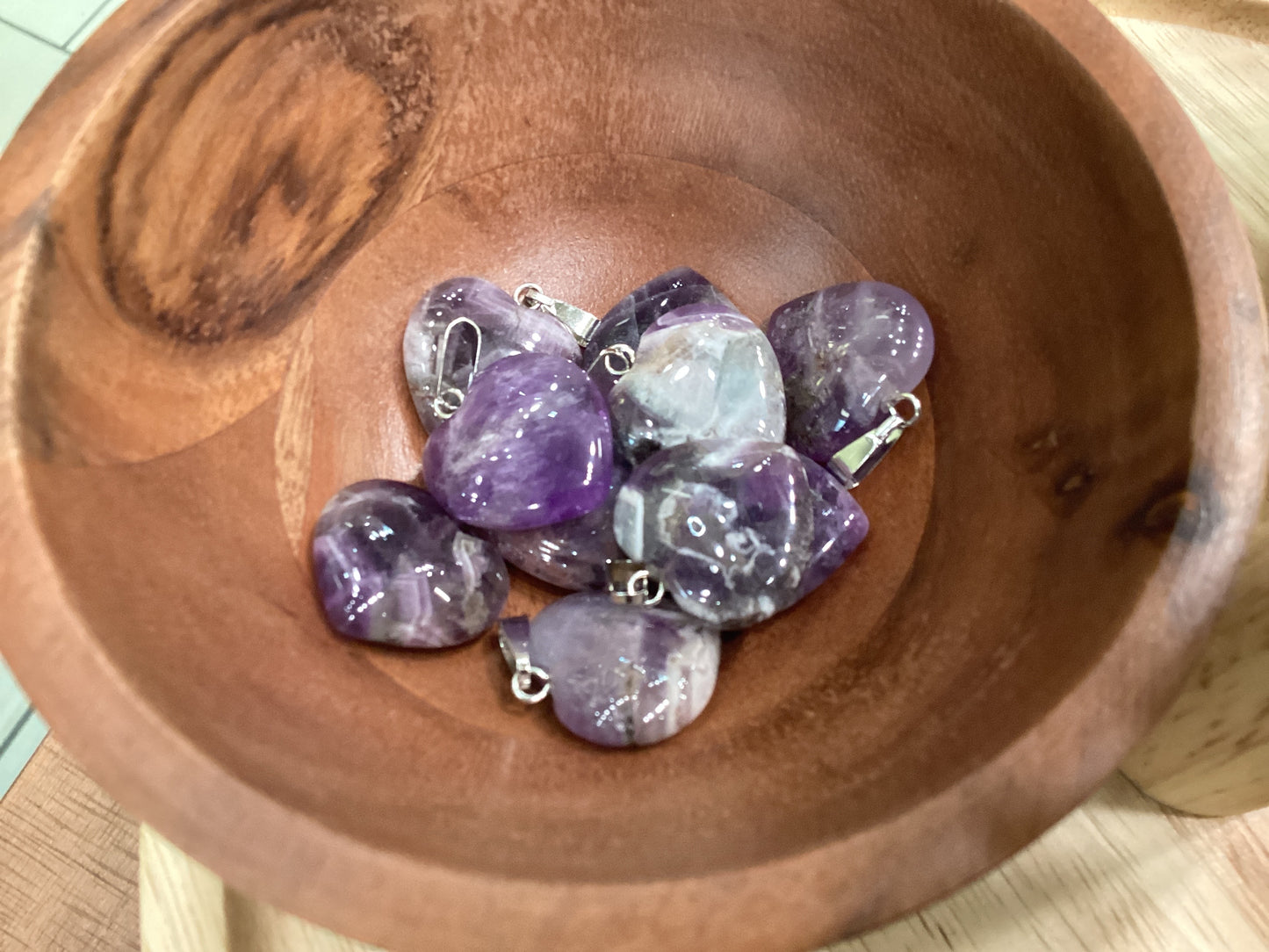 Heart-shaped purple amethyst necklace charms with silver clasps.